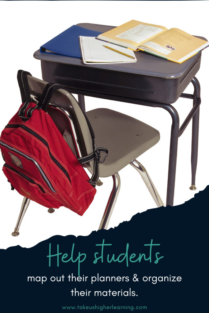 Image showing a student's desk with a backpack hanging on the chair and a binder, notebook, and textbook sitting on top of the desk.